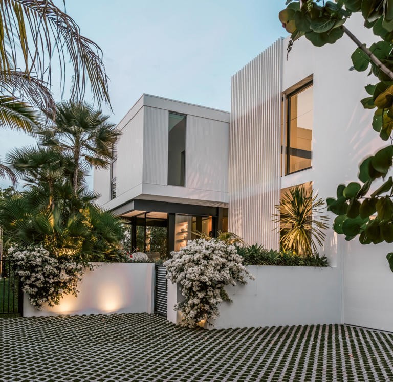 The entry facade of the Biggs House at dusk, bougainvillea in bloom