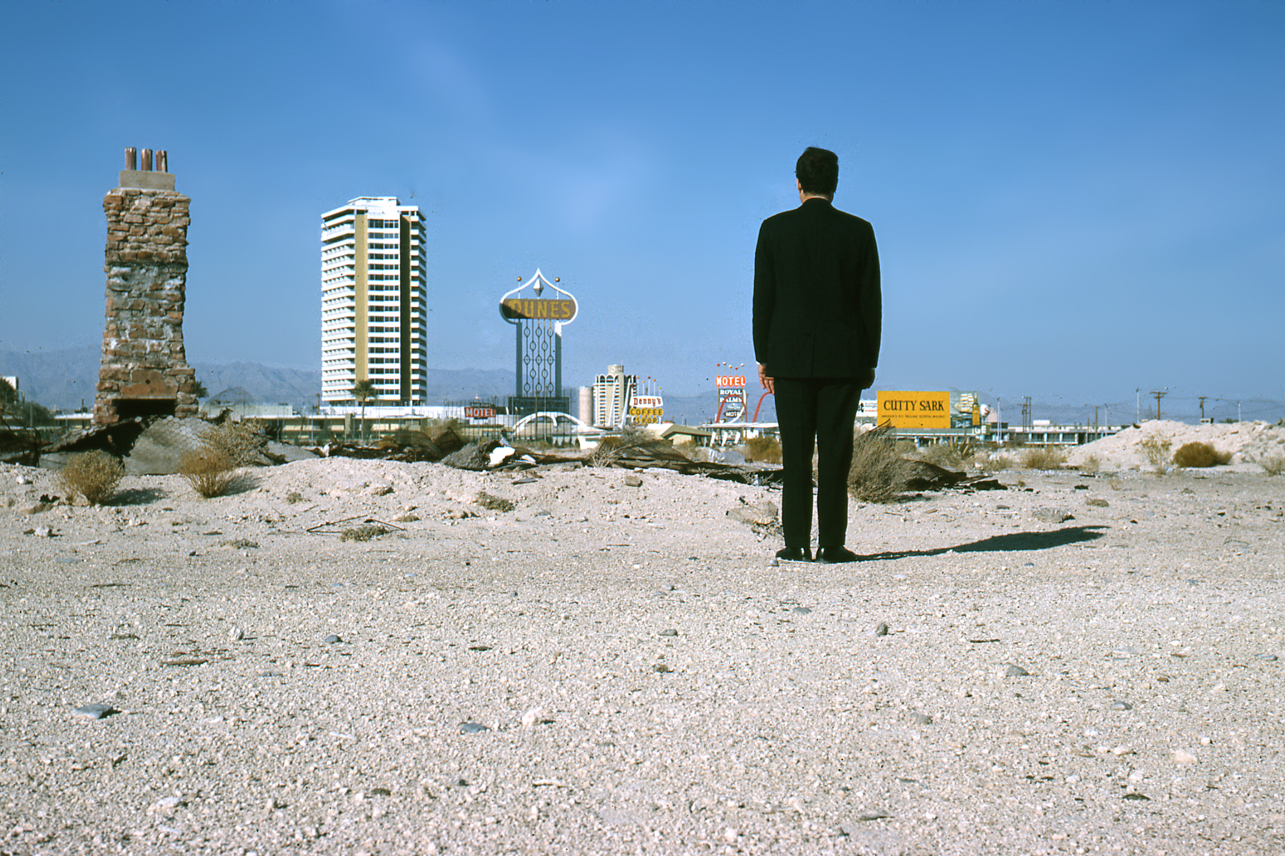 Standing below the title was an iconic image, circa 1965, of the indefatigable architect and planner herself, hands on hips, legs astride a broken-white, highway line – with the Las Vegas Strip looming in the background.