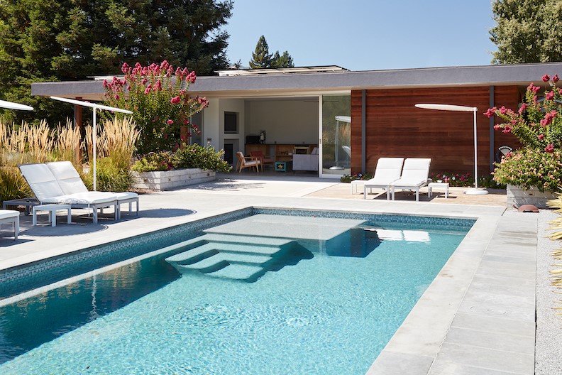 “There are the outdoor spaces out by the pool, then some indoor under the roof, and all are connected to and protected from nature in a small pool house/guest house.”