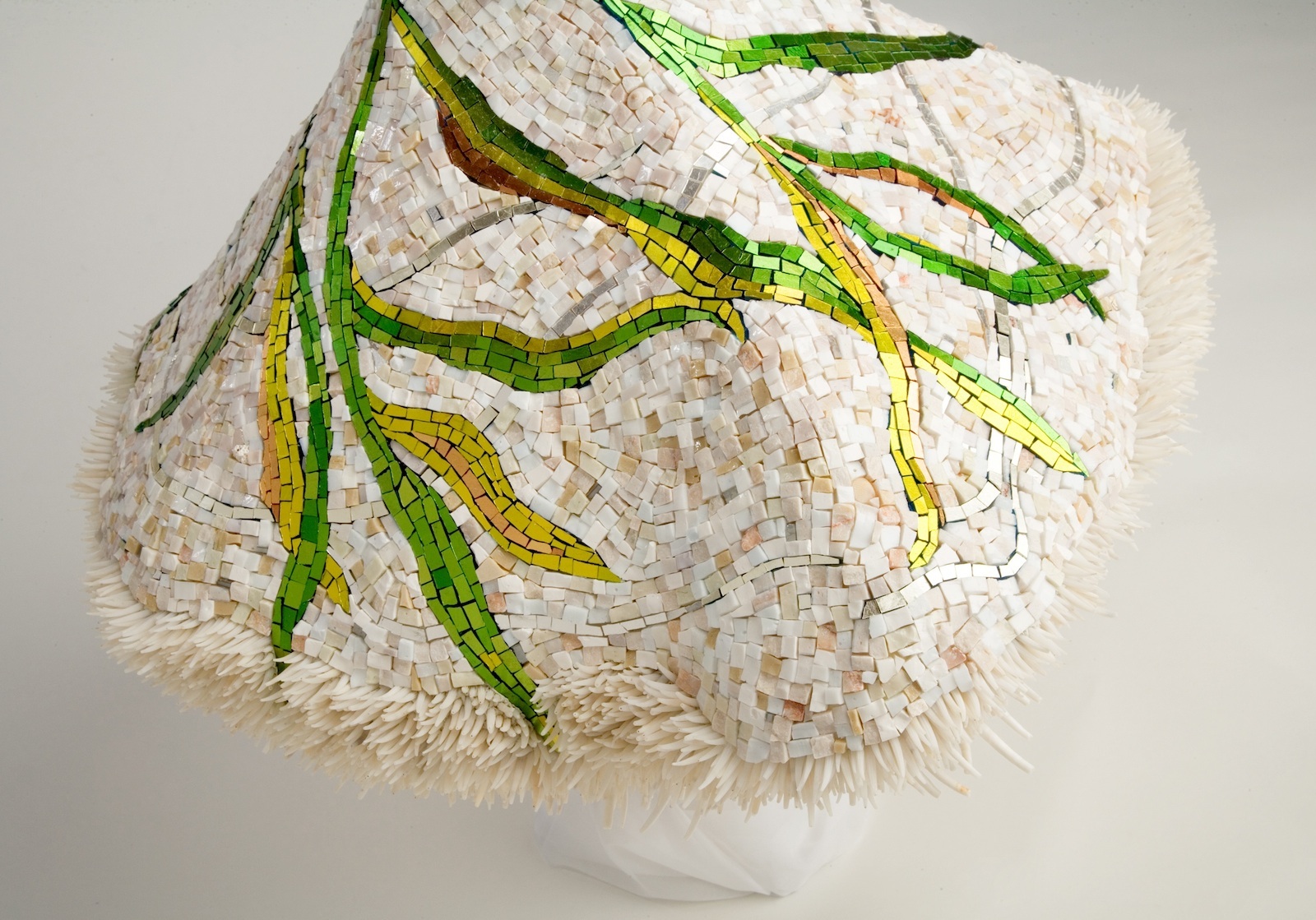 She started with a tiny torso that a jeweler might use to display precious gems. She added carved Styrofoam, then fiberglass mesh and a skim coat of Thinset.